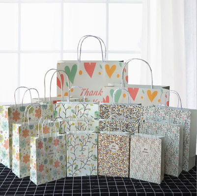 Las bolsas de papel recicladas que llevan fuertes con el aniversario Kraft de las manijas sacan bolsos
